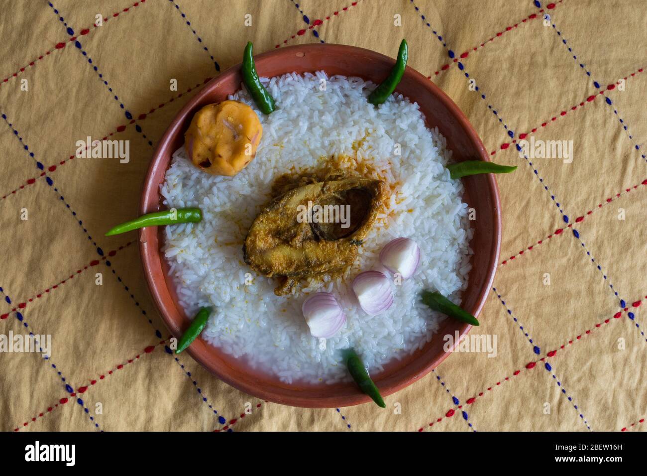 Traditional Bengali foods on earthen plate named Panta Ilish and Alu
