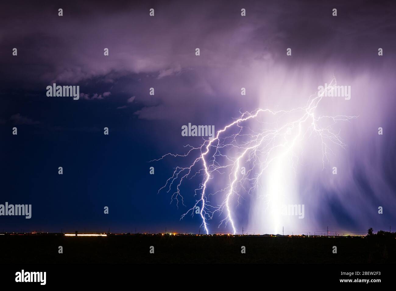 Night sky and lightning storm with bolts striking over the city in Casa Grande, Arizona Stock Photo