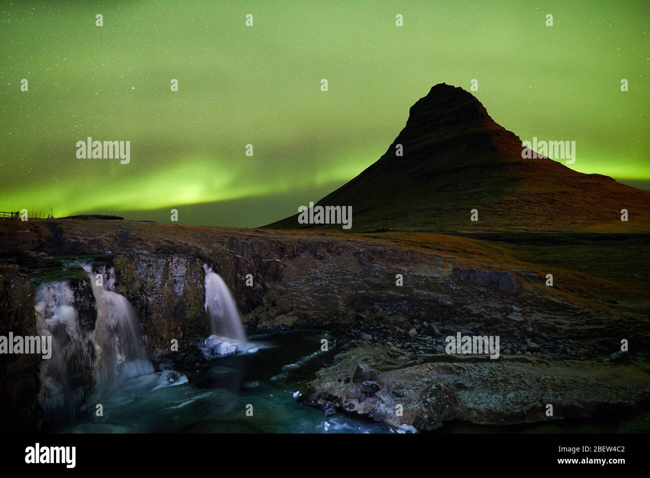 Kirkjufellsfoss, Iceland - Nov 27, 2019: Long exposure during sunset over the Kirkjufellsfoss Waterfall with Kirkjufell Mountain in the background Stock Photo
