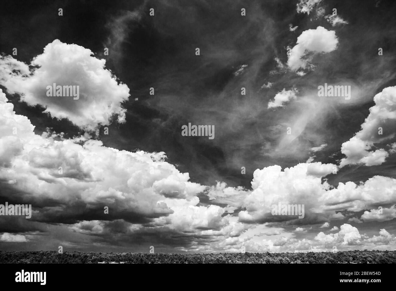 Black & white view of beautiful cumulus clouds against azure blue sky; southwestern USA Stock Photo