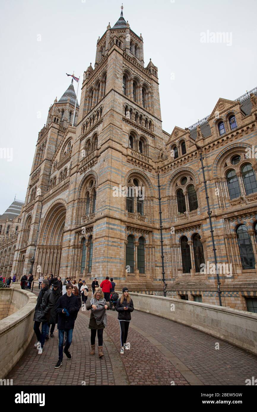 Visitors to the Natural History Museum dwarfed by the buildings grand size Stock Photo