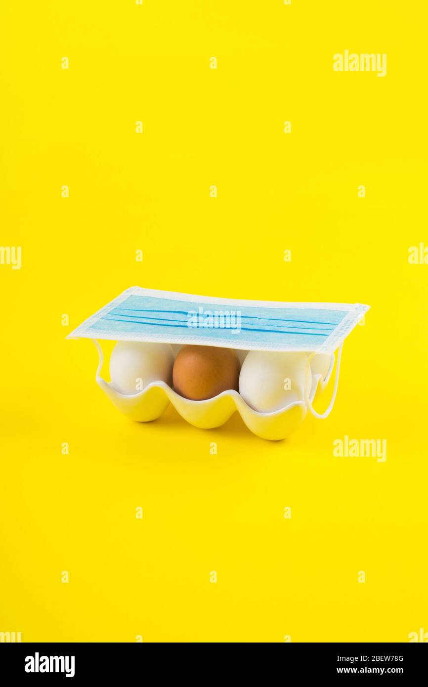 Download White And One Brown Egg On Yellow Under Face Mask Stock Photo Alamy PSD Mockup Templates