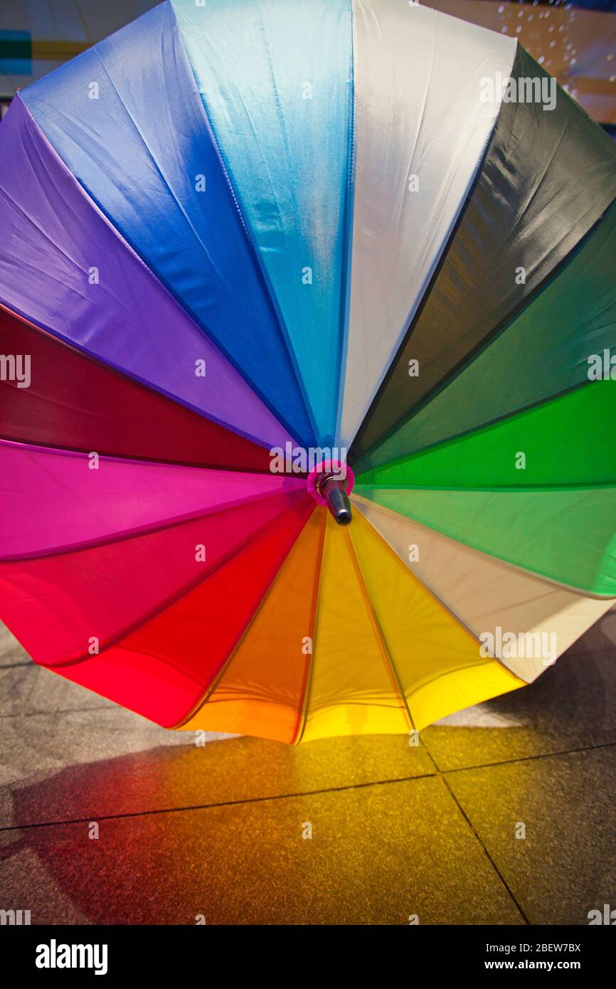 Rainbow umbrella Spitalfields Market. Stock Photo