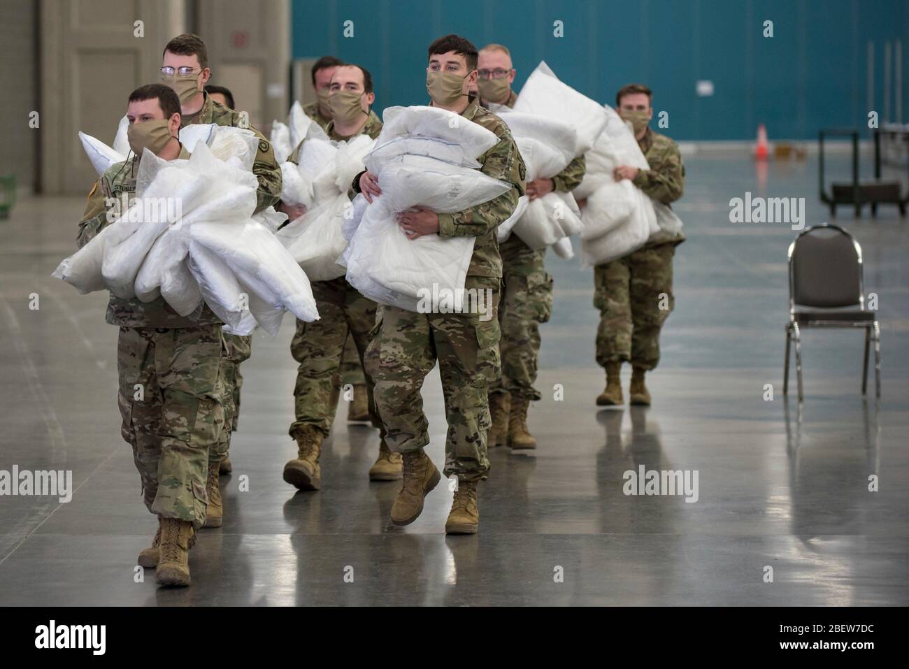 Kentucky Army National Guard soldiers distribute hospital bed pillows for an Alternate Care Facility to treat COVID-19, coronavirus pandemic patients set up at the Kentucky Fair and Exposition Center April 14, 2020 in Louisville, Kentucky. Stock Photo