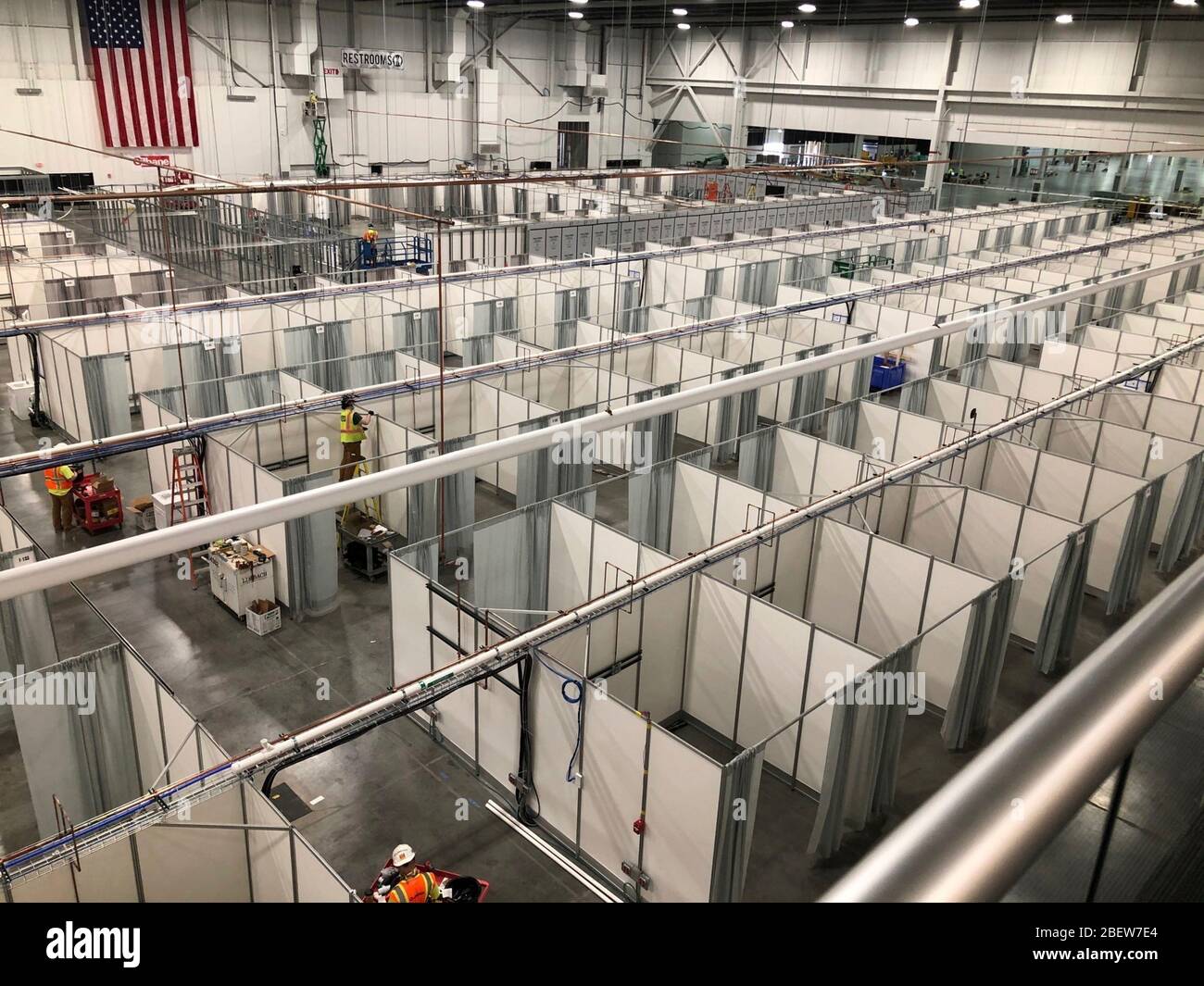 Hundreds of hospital beds cover the floor at a Federal Medical Station COVID-19, coronavirus pandemic relief facility set up at the Suburban Collection Showcase April 14, 2020 in Novi, Michigan. Stock Photo