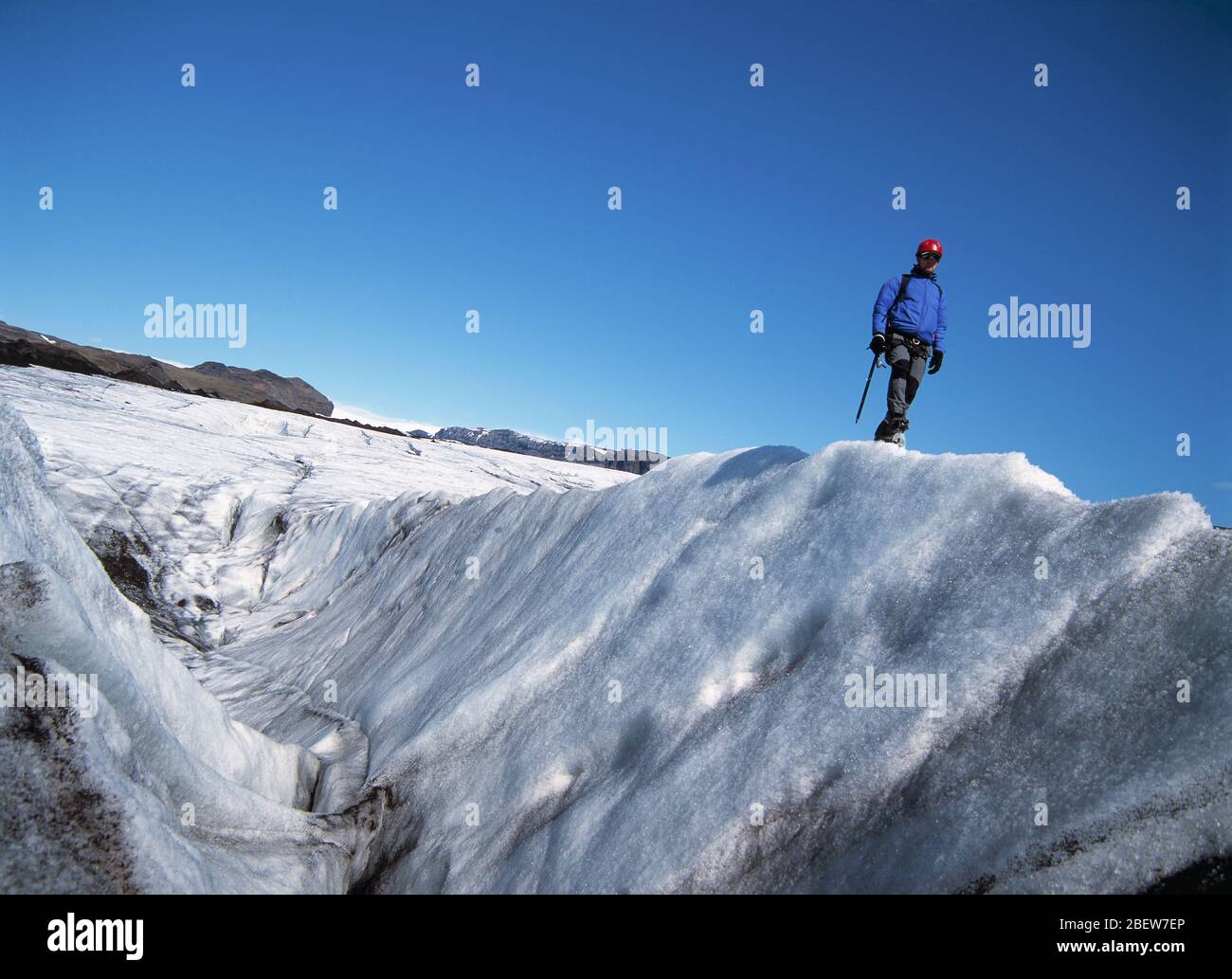 man exploring the glacier Solheimajokull in Iceland Stock Photo