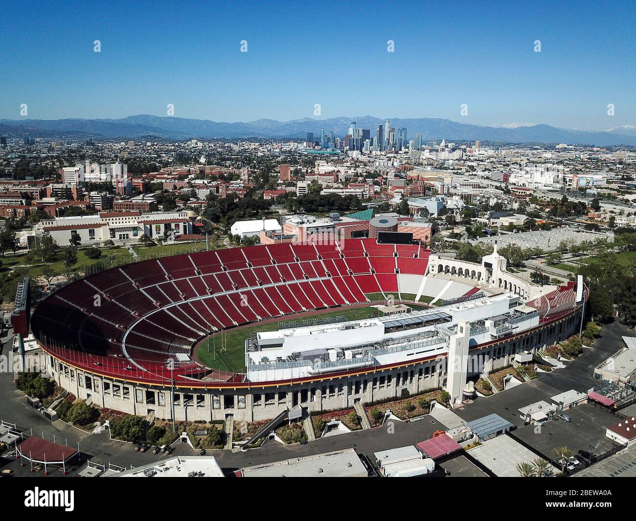 Los Angeles, California, USA. 15th Apr, 2020. An aerial view shows the Los Angeles Memorial Coliseum with downtown Los Angeles skyline in background on April 15, 2020. Los Angeles Mayor Eric Garcetti said today he doesn't foresee large gatherings, such as sporting events and concerts, happening in the city until 2021, as the region continues to reel from the COVID-19 pandemic. Credit: Ringo Chiu/ZUMA Wire/Alamy Live News Stock Photo