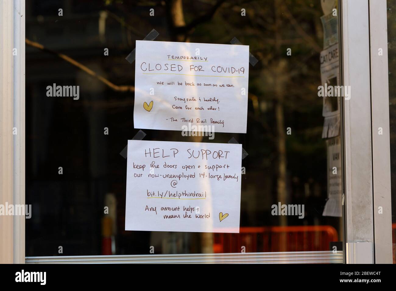 Signs at a door to a coffee shop in the East Village of Manhattan saying it is temporarily closed due to coronavirus... SEE MORE INFO FOR FULL CAPTION Stock Photo
