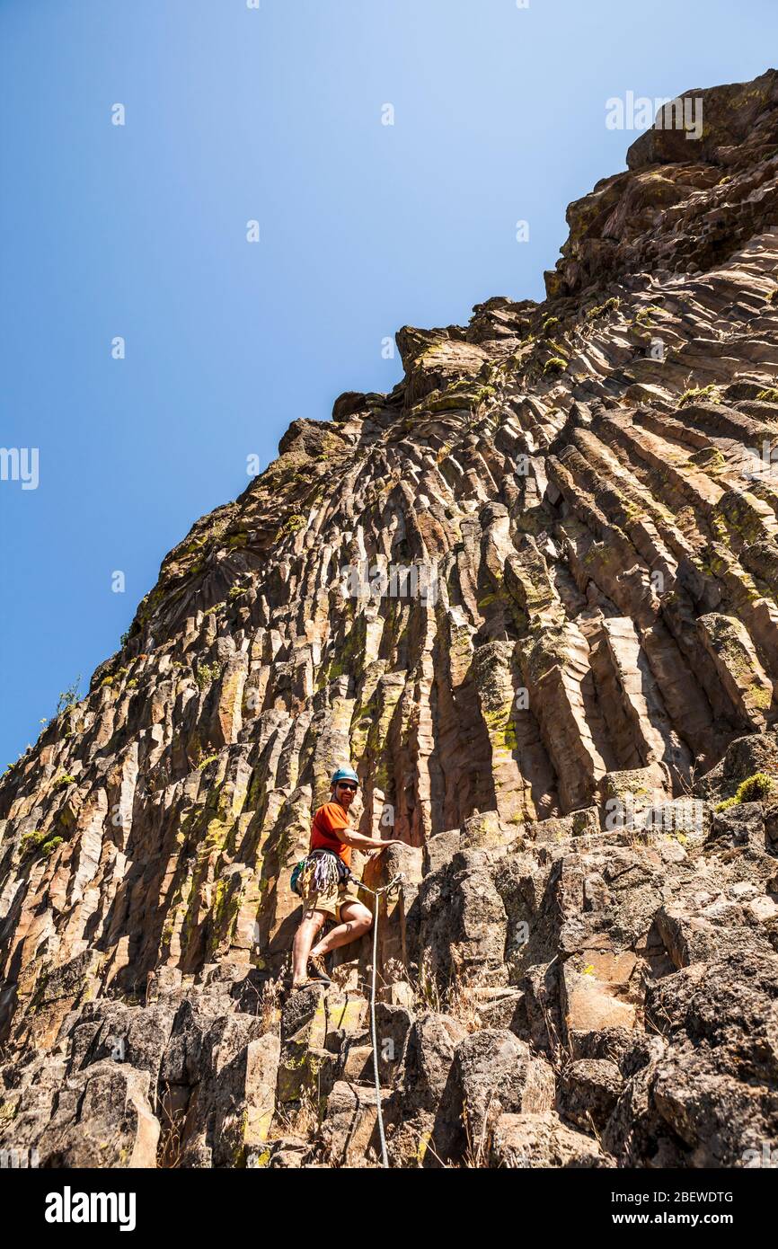 A man climbing a cliff in the Tieton river Canyon, Washington, USA
