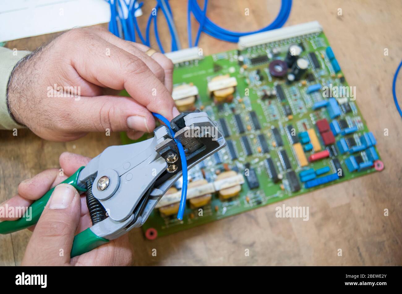 an electric technician with an electronic board performing maintenance