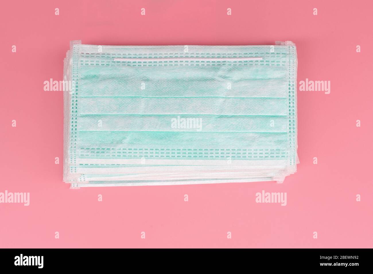 Heap Medical face mask, Medical protective mask on pink background. Disposable surgical face mask cover the mouth and nose. protect Healthcare and Stock Photo