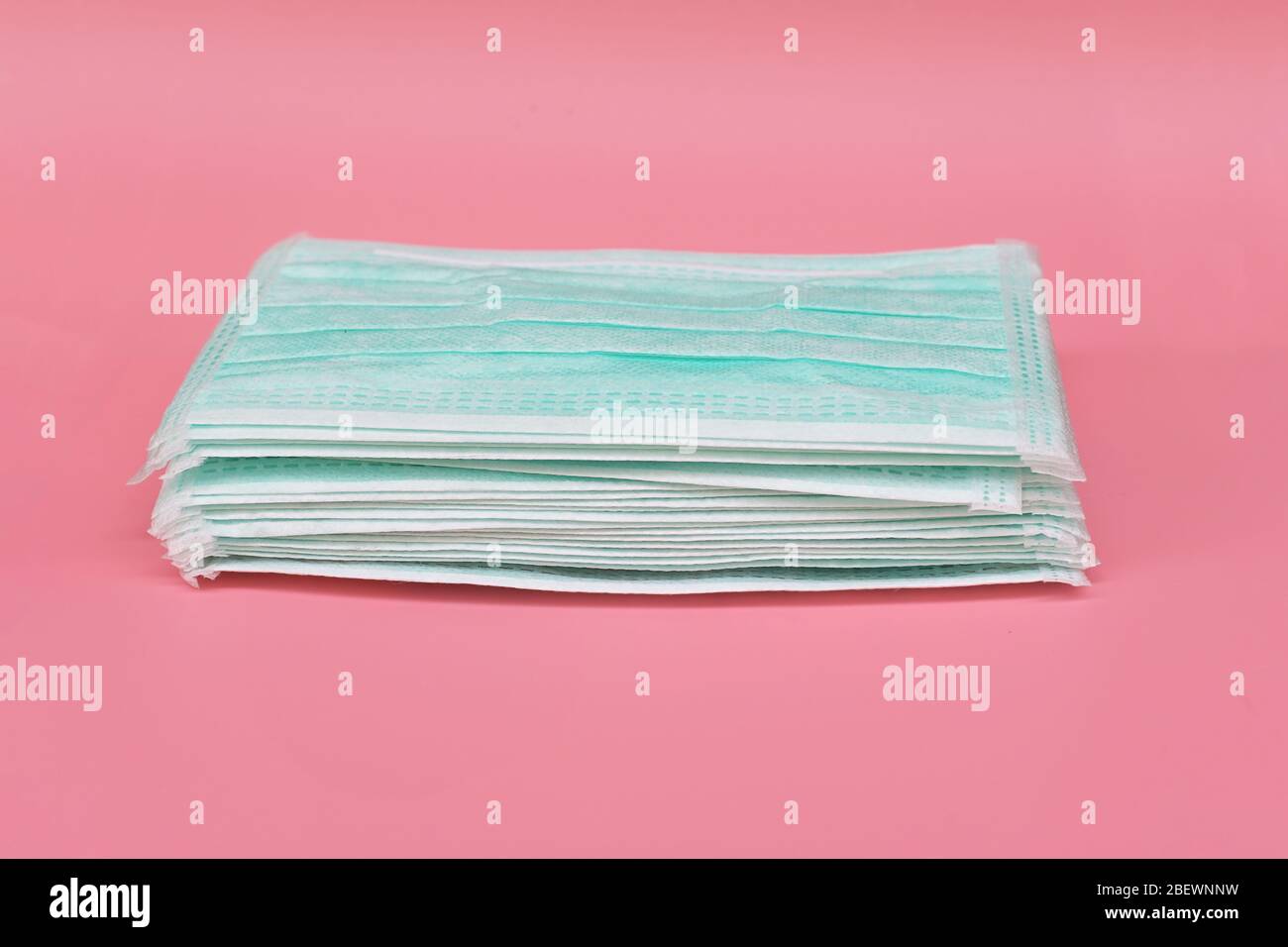 Heap Medical face mask, Medical protective mask on pink background. Disposable surgical face mask cover the mouth and nose. protect Healthcare and Stock Photo