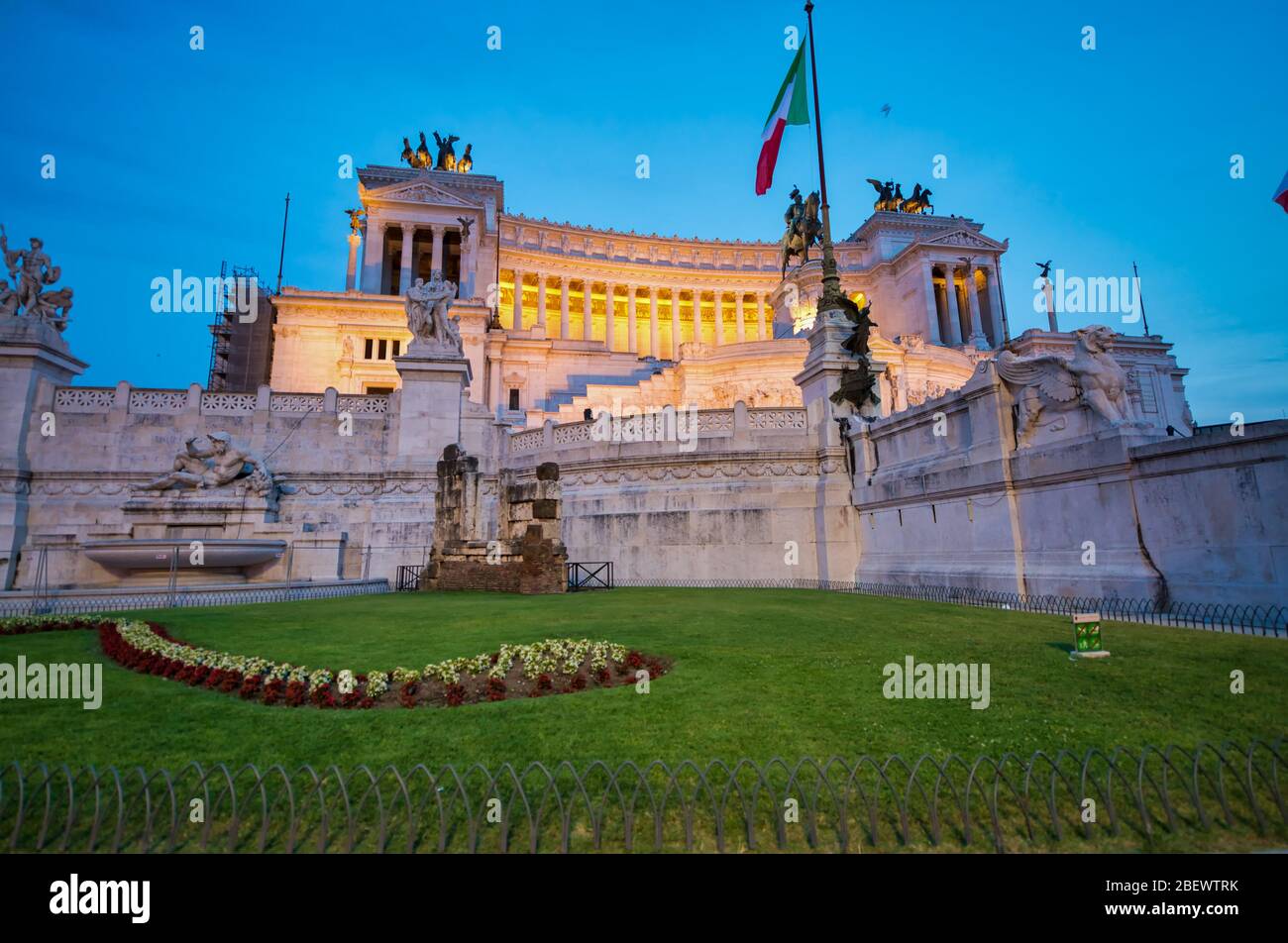 ROME, ITALY - JUNE 2014: Tourists visit Venice Square at dusk. The city attracts 15 million people annually. Stock Photo