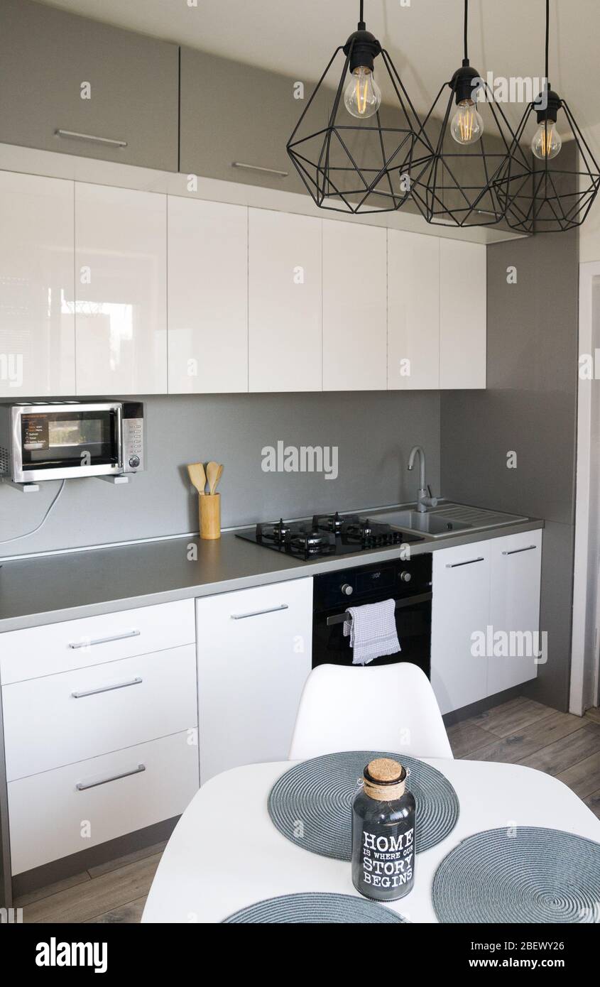 Stylish kitchen with with elegant shiny table and stove Stock Photo - Alamy