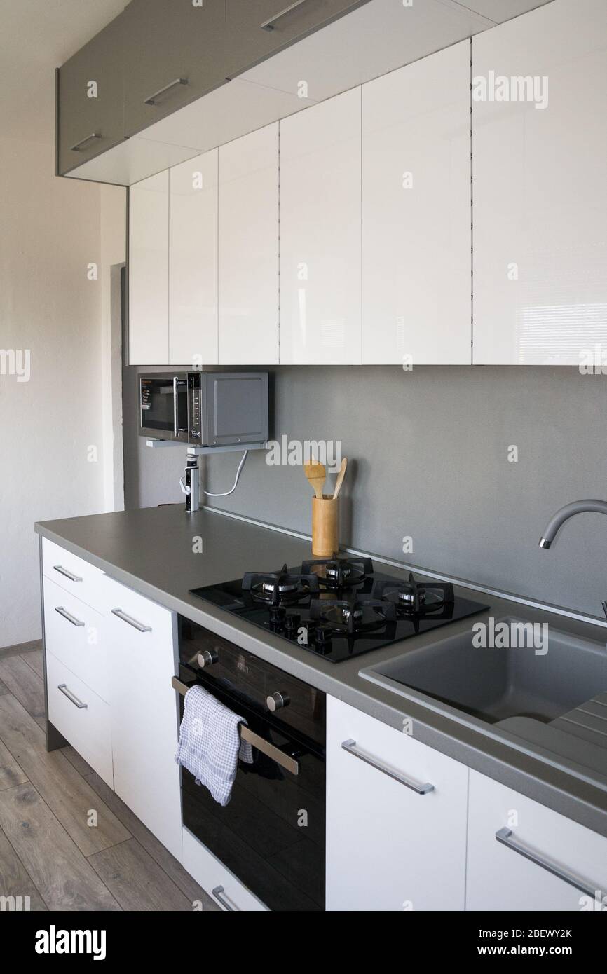 Stylish kitchen with with elegant shiny table and stove Stock Photo - Alamy