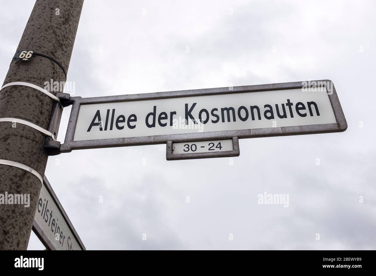 Streetsign for Allee der Kosmonauten, on an overcast day, in Marzahn, Berlin, Germany Stock Photo