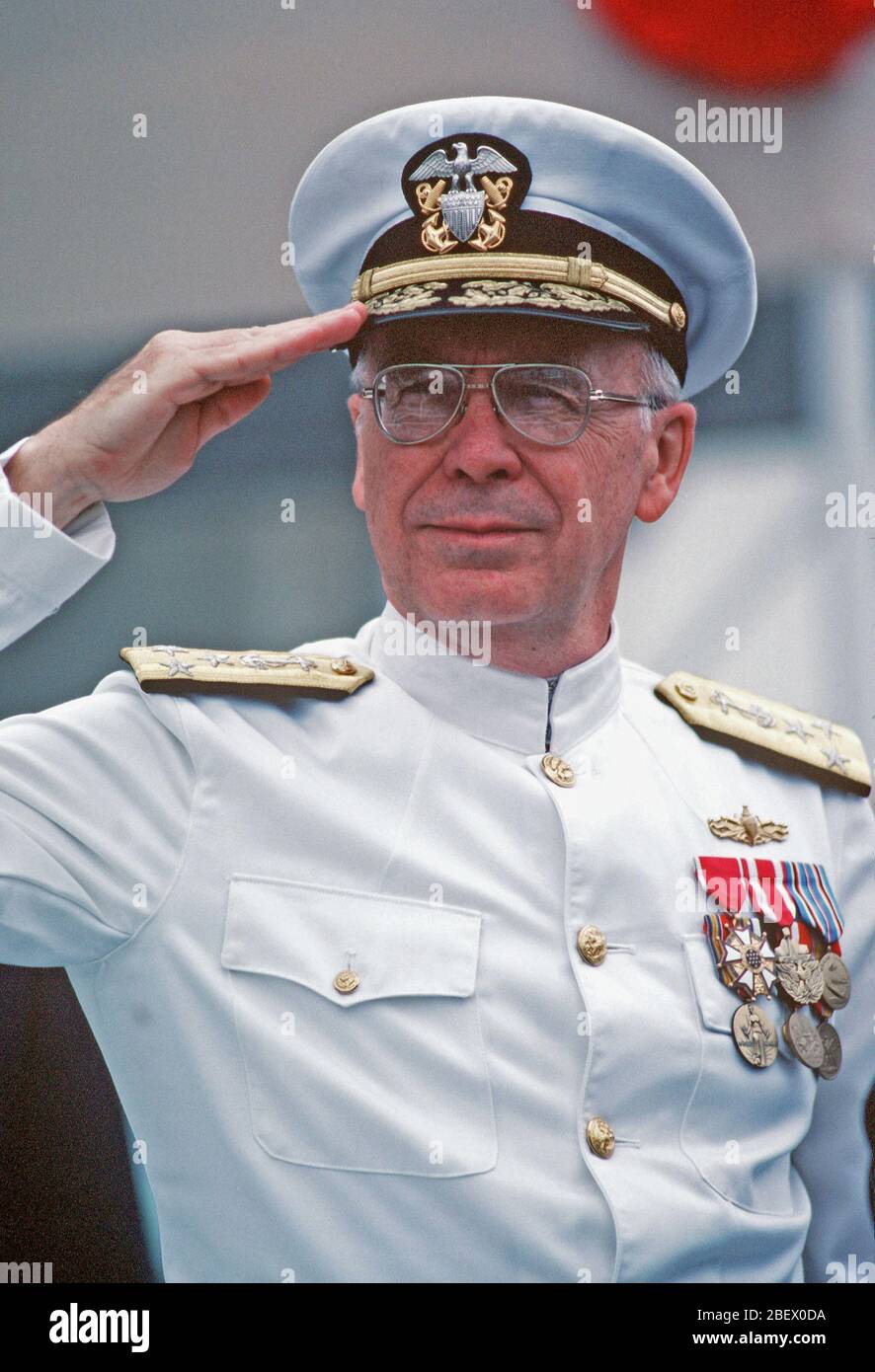 1982 - VADM Robert L. Walters, deputy chief of naval operations, Surface Warfare, salutes during the launching ceremony for the nuclear-powered attack submarine USS BUFFALO (SSN-715). Stock Photo