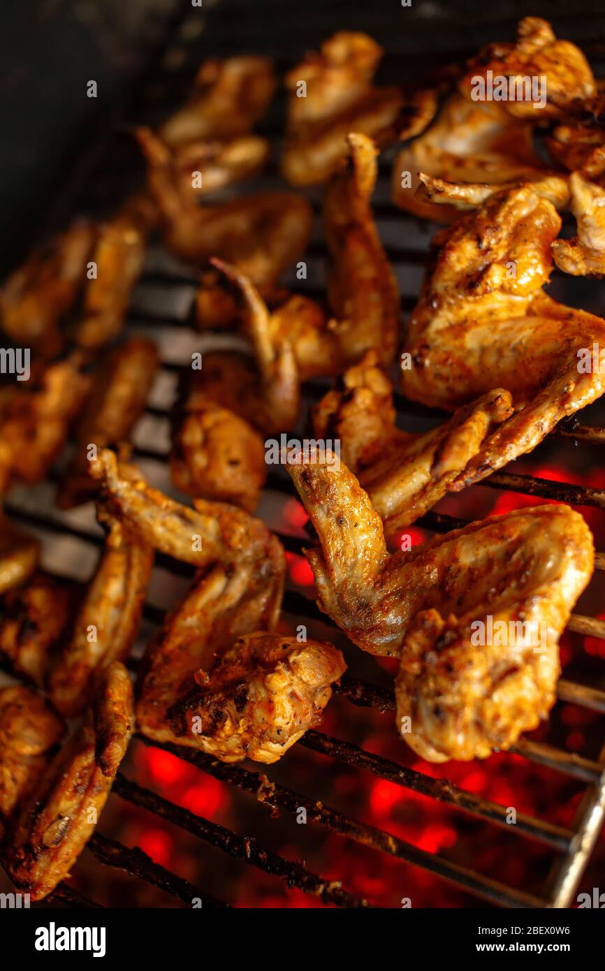 Grilled spicy chicken wings. Marinated chicken meat roasted on a grill ...