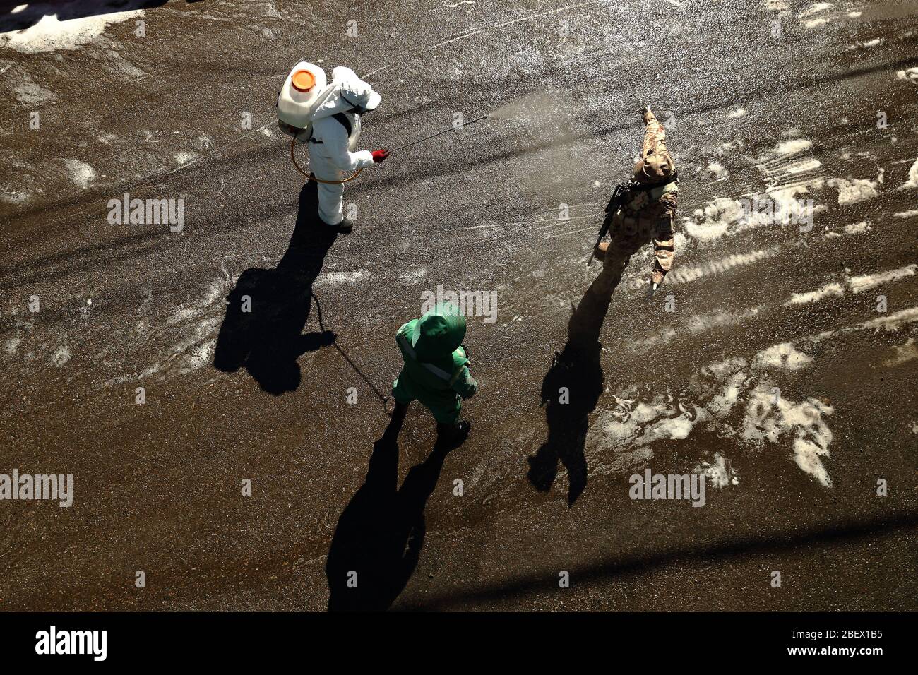 Arequipa, Peru. 15th Apr, 2020. Cleaners are on duty because of the novel corona virus and disinfect a member of the military. Credit: Denis Mayhua/dpa/Alamy Live News Stock Photo