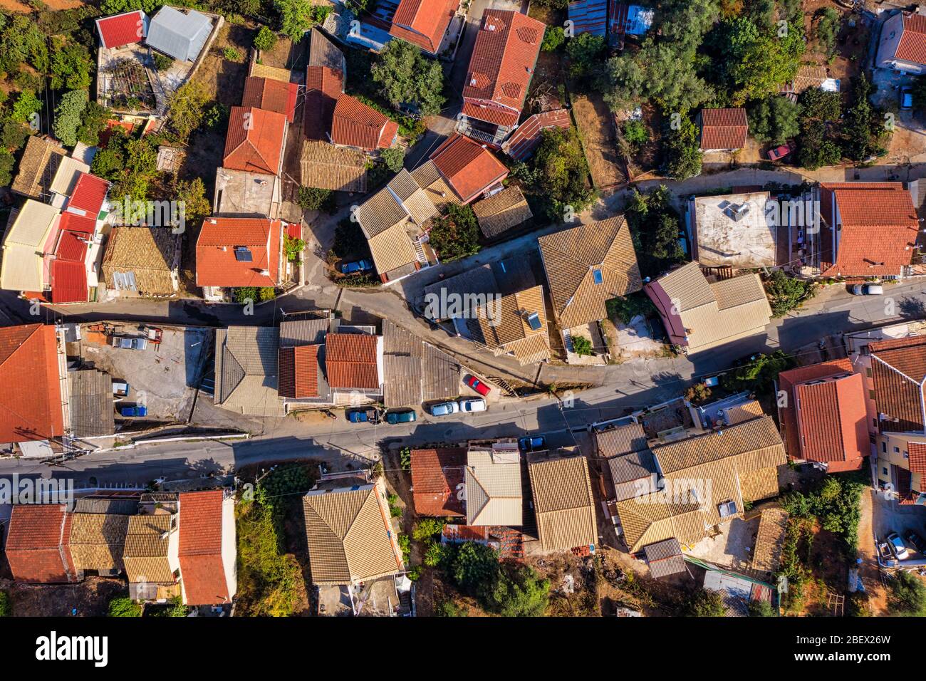 Aerial of colorful red tiled rooftops in mediterranean village. Greek architecture. A small town on Corfu island in Greece Stock Photo