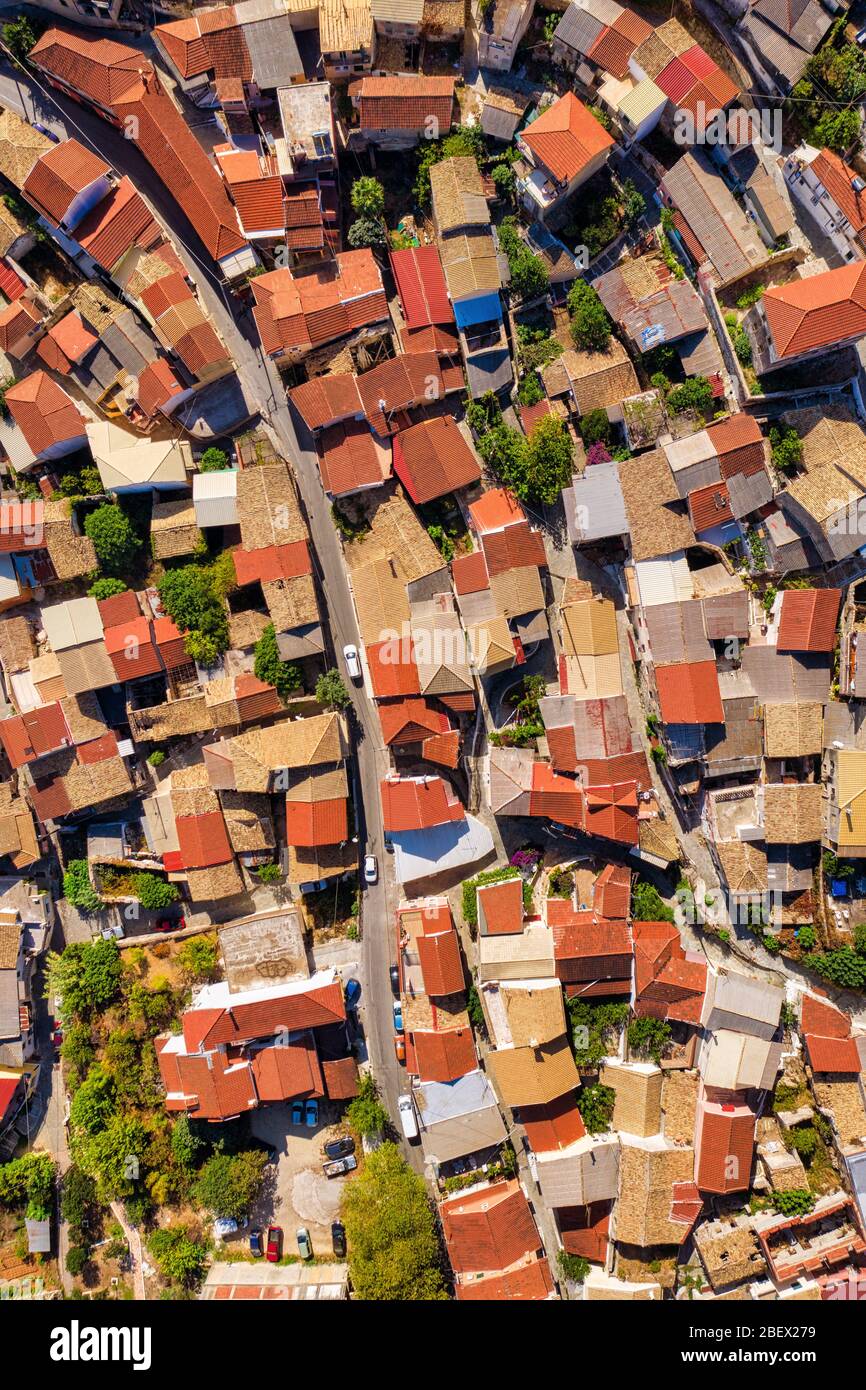 Aerial of red tiled roofs of old town in Mediterranean. Rooftops of ancient greek village Stock Photo
