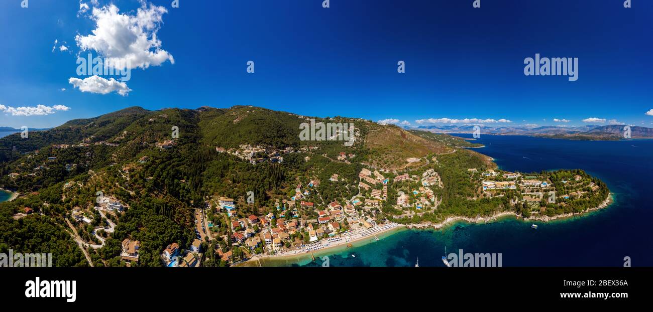 Mediterranean island Corfu aerial panorama. A resort in Greece. Kalami village from the air. Green island with torquoise water on a sunny day Stock Photo