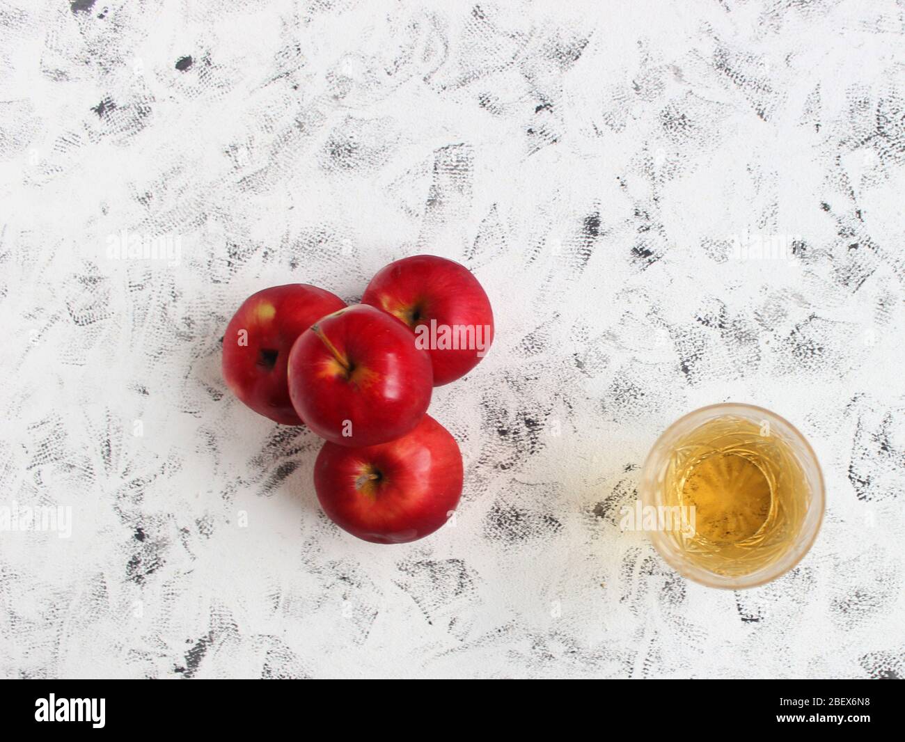 Light Apple Juice In A Crystal Glass And Ripe Red Apples On A White Table On A Background Of A White Brick Wall Stock Photo Alamy