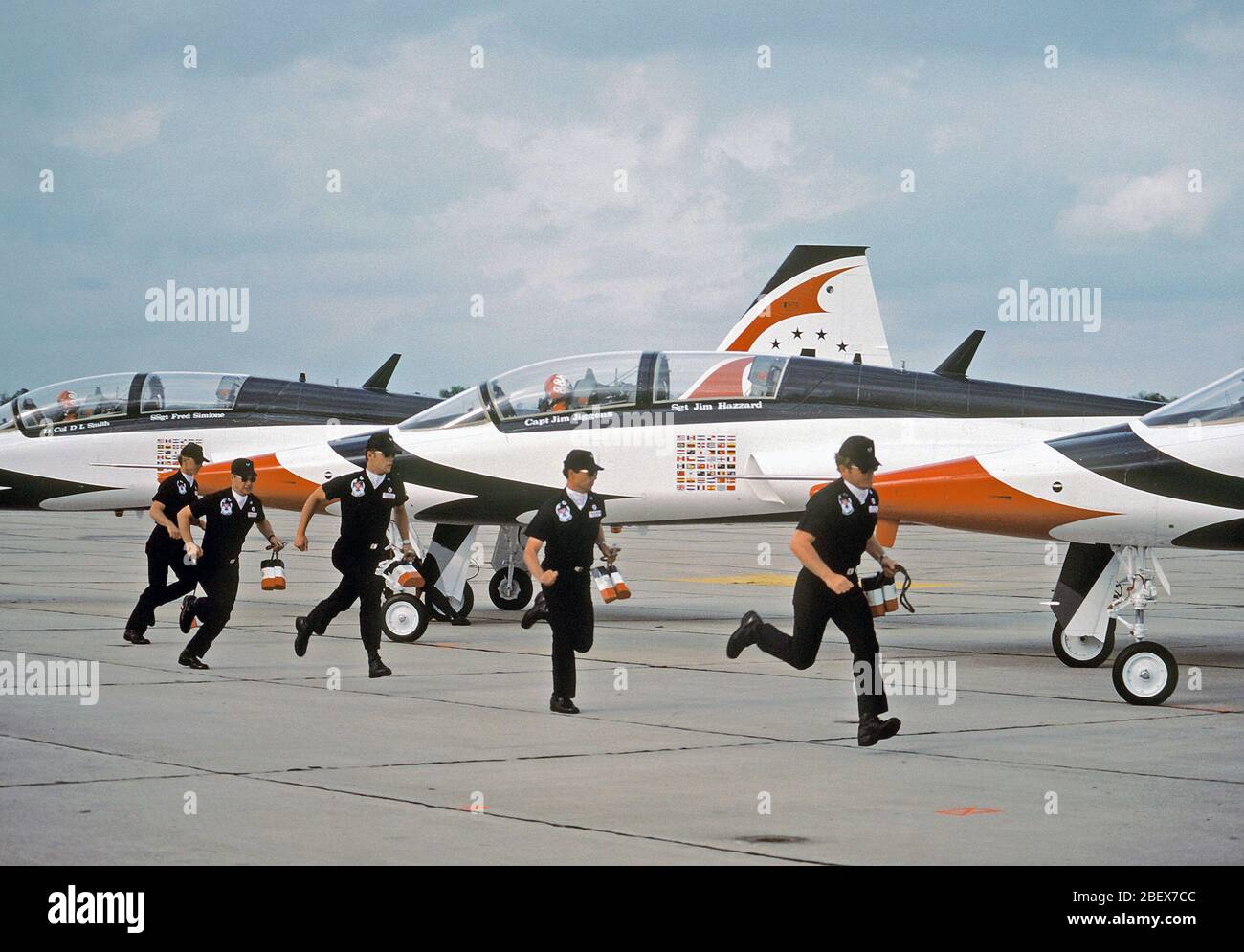1980 - Crew chiefs of the Thunderbirds team run to their T-38 Talon aircraft for preflight activities Stock Photo