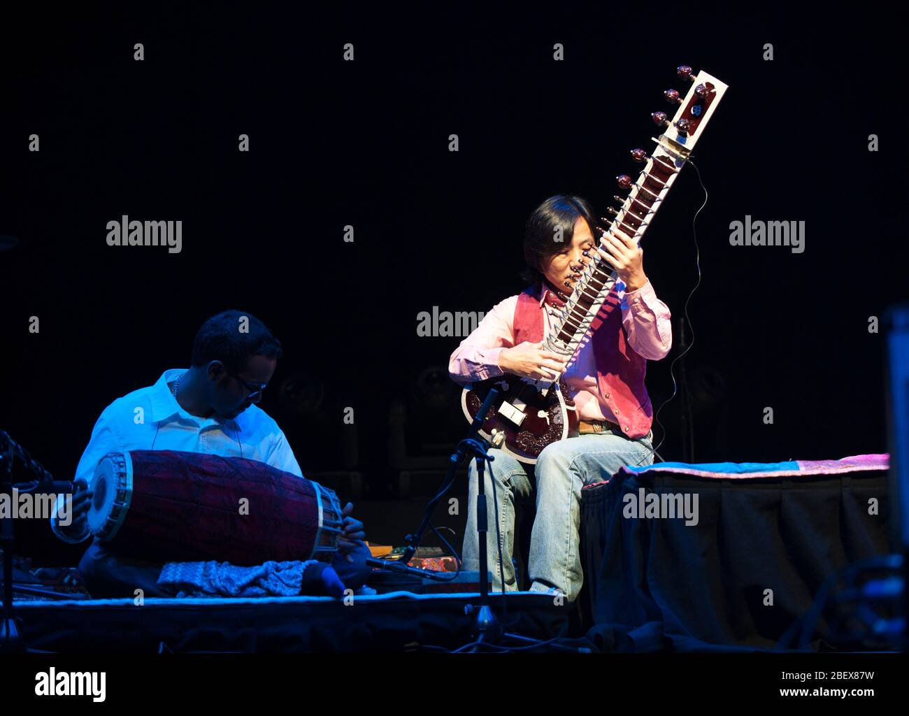 Pirashanna Thecarajah (mridangam) and Kenji Ota (tuning a sitar) at the Songlines Magazine World Music Awards, The Barbican, London 2012 Stock Photo