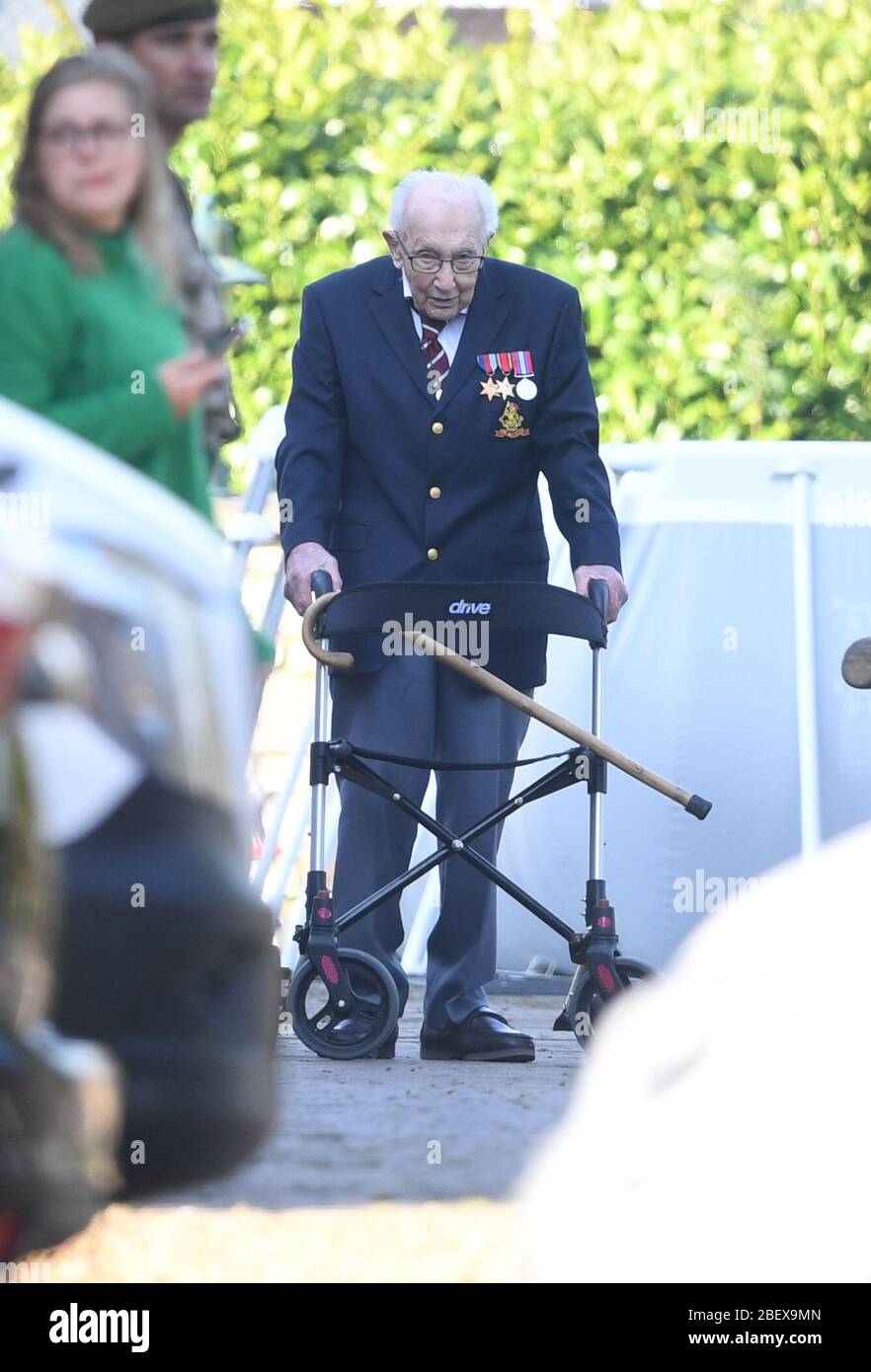 Captain Tom Moore, a 99-year-old veteran, completing the 100th length of his garden. Captain Moore has raised over 12 million pounds for the NHS after receiving donations to his fundraising challenge from around the world. Stock Photo
