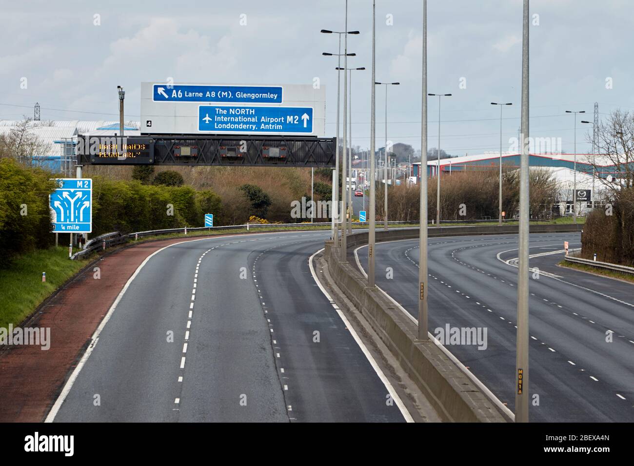 empty m2 motorway with wash hands regularly motorway sign during coronavirus lockdown in Newtownabbey Northern Ireland UK Stock Photo