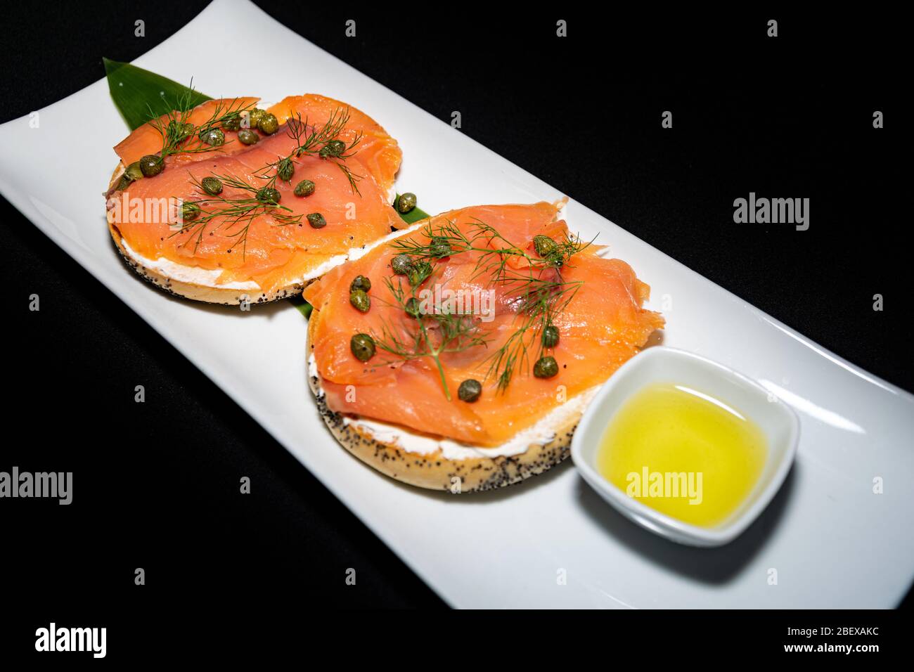 A Breakfast Bagel Filled With Smoked Salmon And Cream Cheese Spread With Garlic Oil Dip Stock Photo Alamy