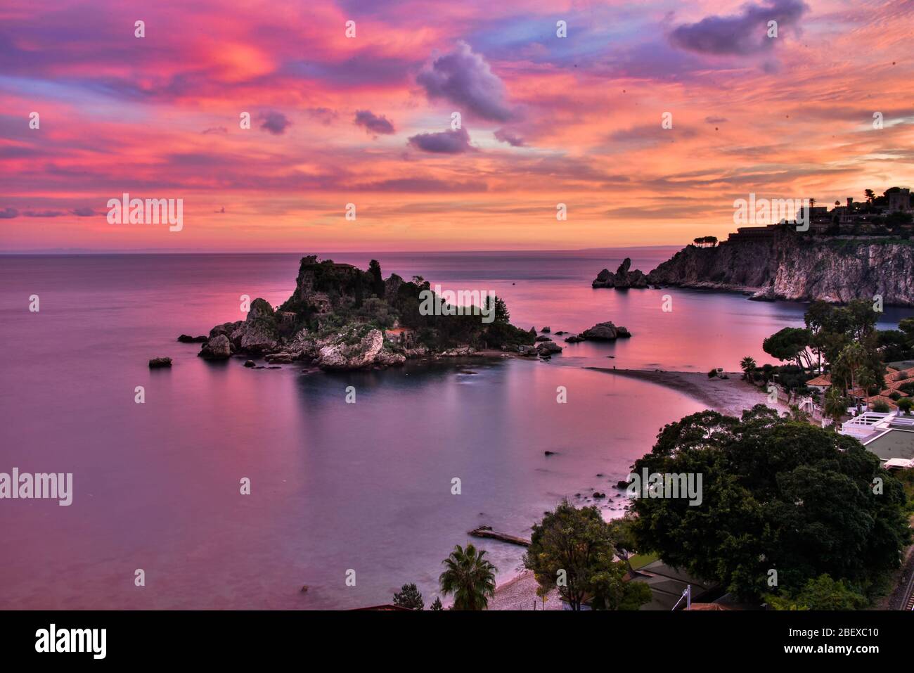 Incredible photo of the sunset sky over the beautiful Isola Bella Nature Reserve in Mazzaro, Taormina, Province of Messina, Sicily Stock Photo