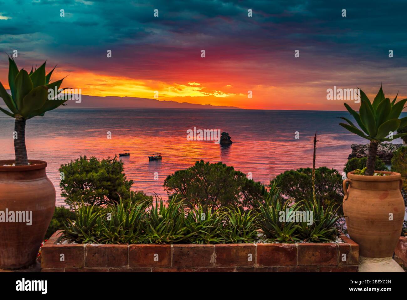 Amazing view of the sunrise by the best beach in Taormina - Mazzaro, near Isolabella Nature Reserve, Sicily Stock Photo