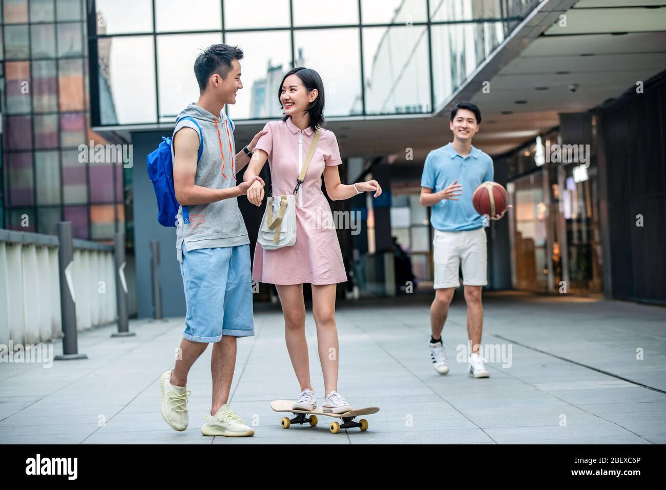 Handsome students goddaughter friend skateboarding Stock Photo