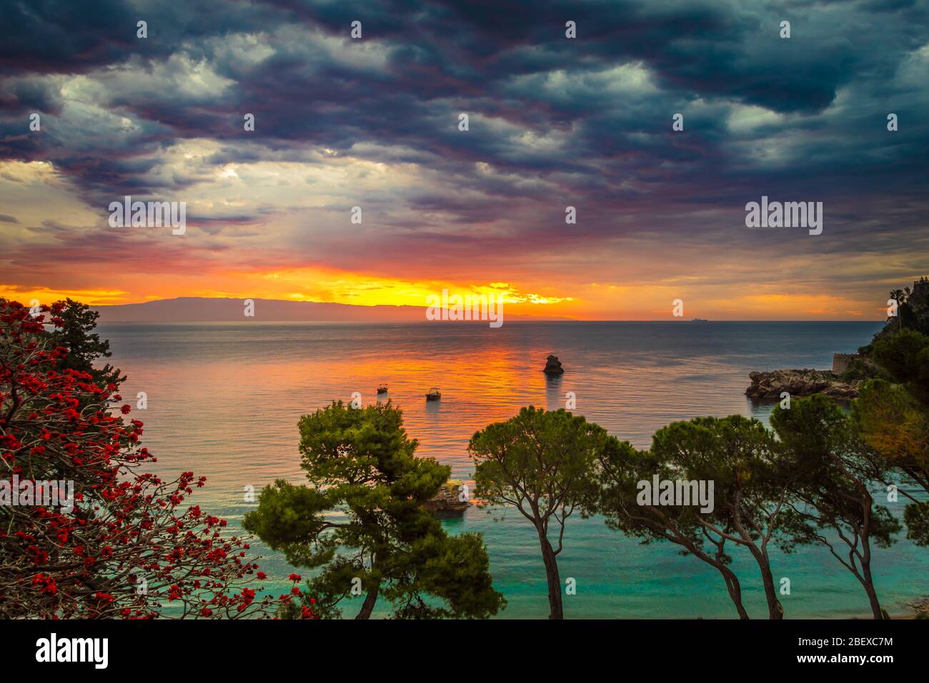Amazing view of the sunrise by the best beach in Taormina - Mazzaro, near Isolabella Nature Reserve, Sicily Stock Photo
