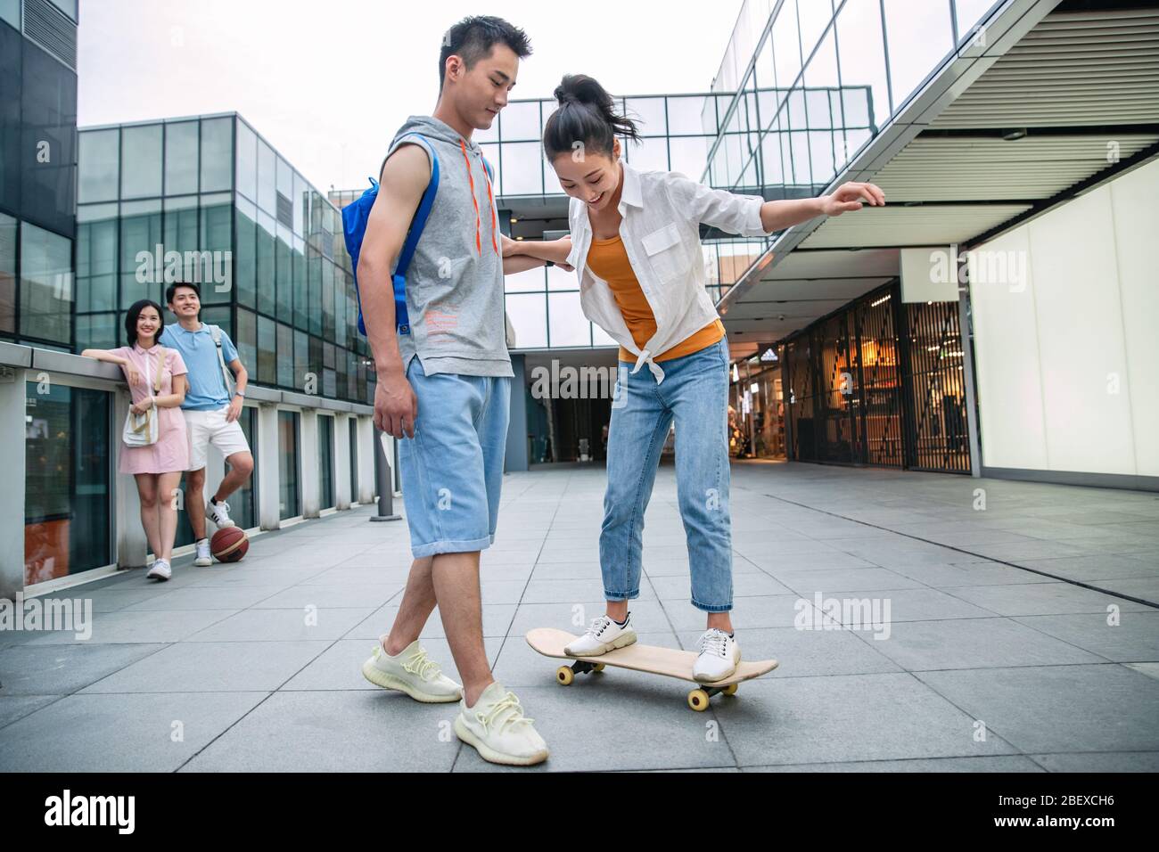 Handsome students goddaughter friend skateboarding Stock Photo