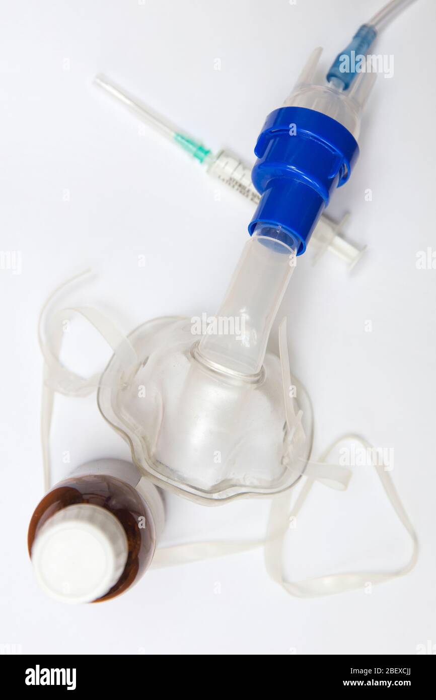 Medical equipment for inhalation with respiratory mask, nebulizer on the white table Stock Photo