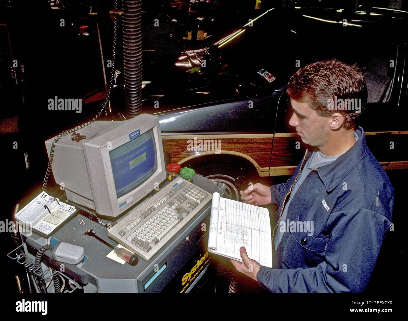 Technician performing an emissions test on a vehicle November 11, 1992