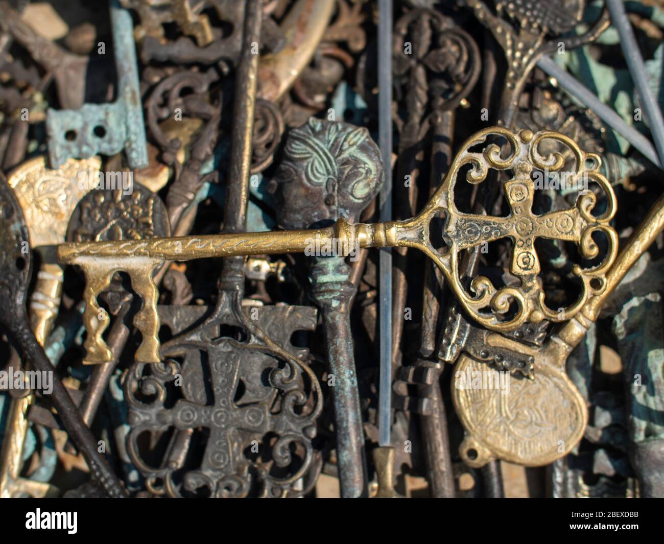 brass key on top ofmany old metal keys Stock Photo - Alamy