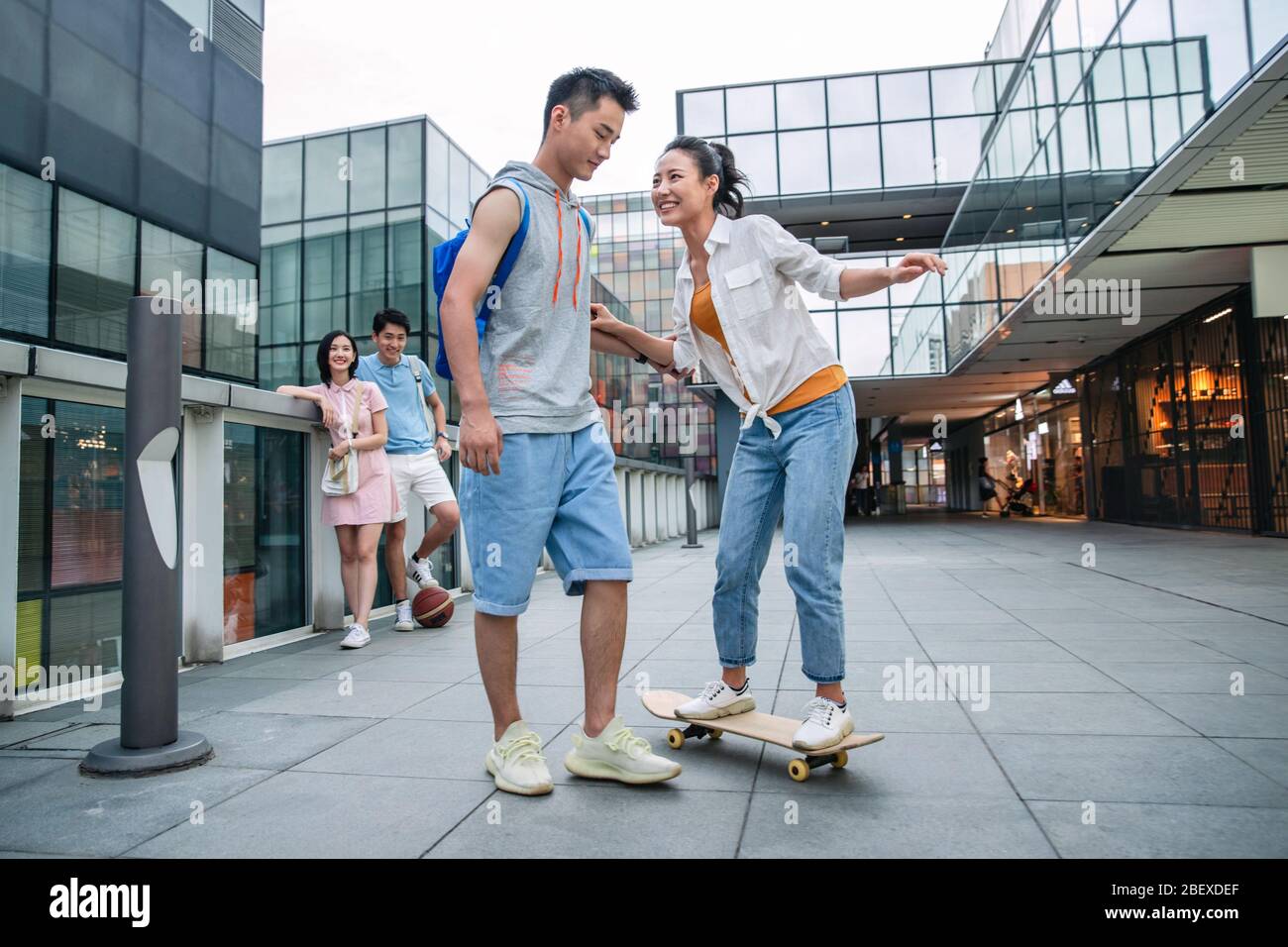 Handsome students goddaughter friend skateboarding Stock Photo