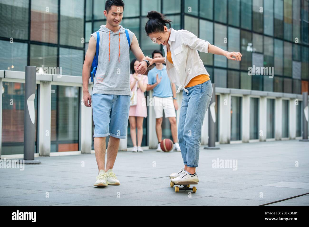 Handsome students goddaughter friend skateboarding Stock Photo