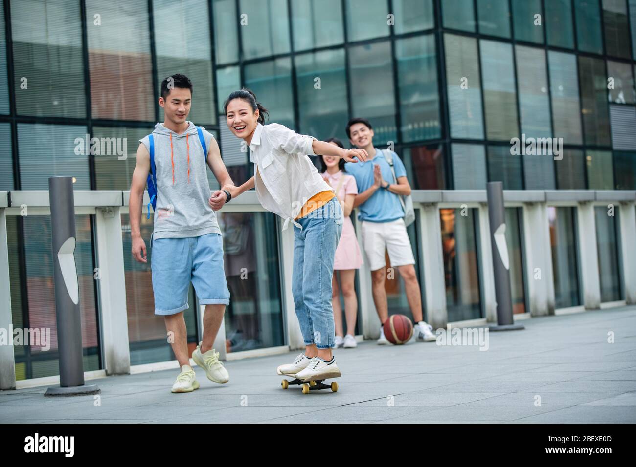 Handsome students goddaughter friend skateboarding Stock Photo