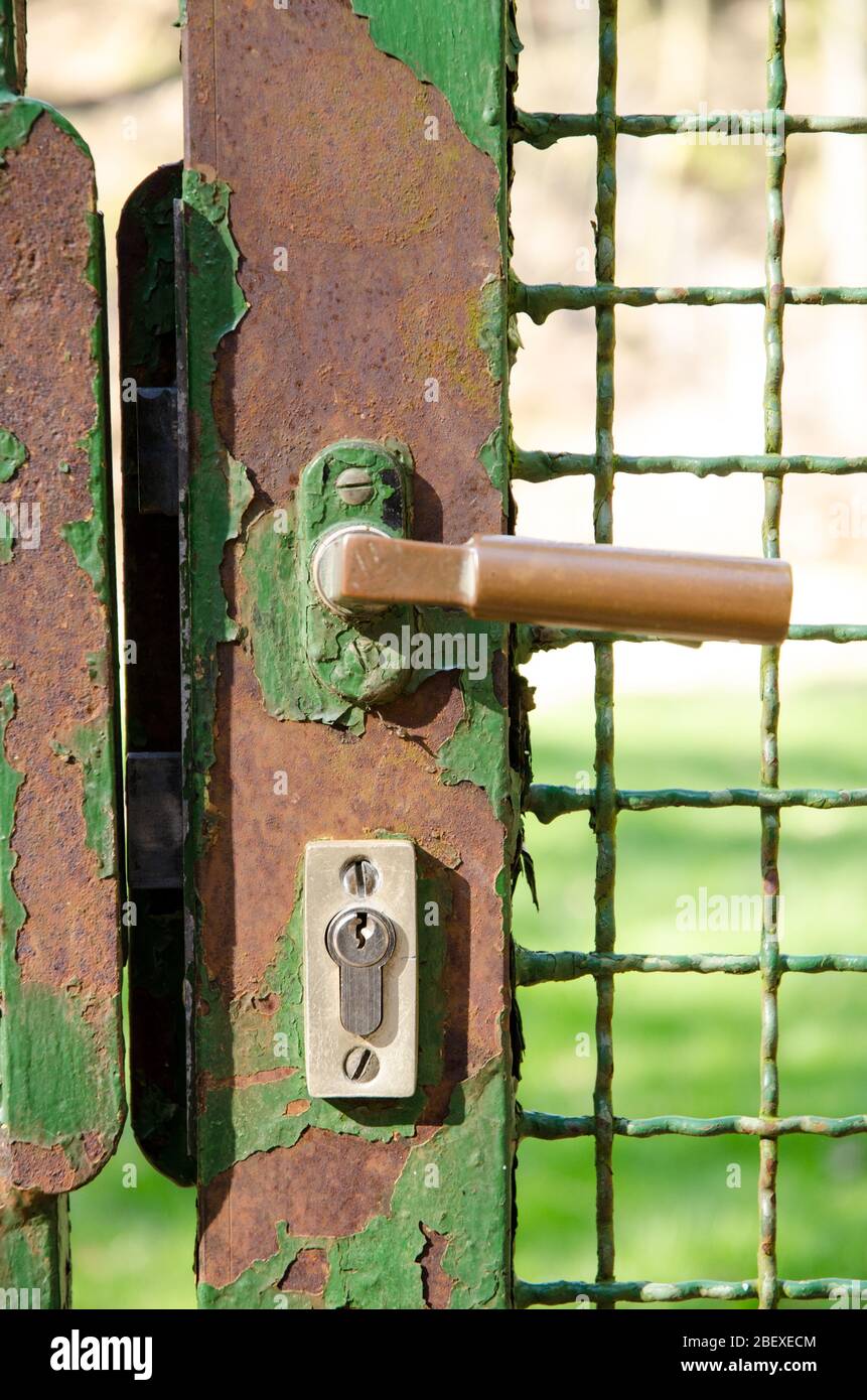 Closed iron gate with handle and lock, Germany, Western Europe Stock