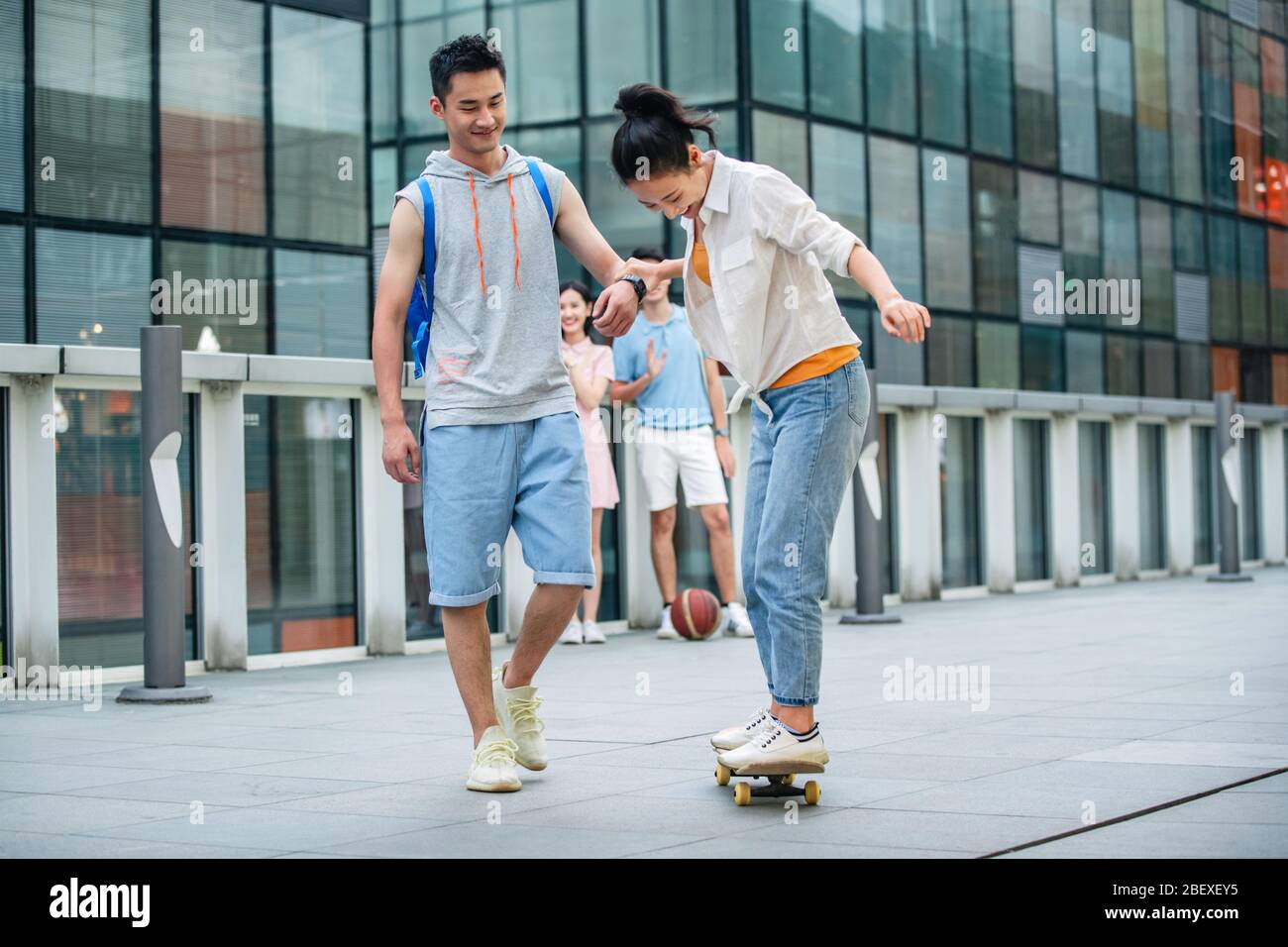Handsome students goddaughter friend skateboarding Stock Photo