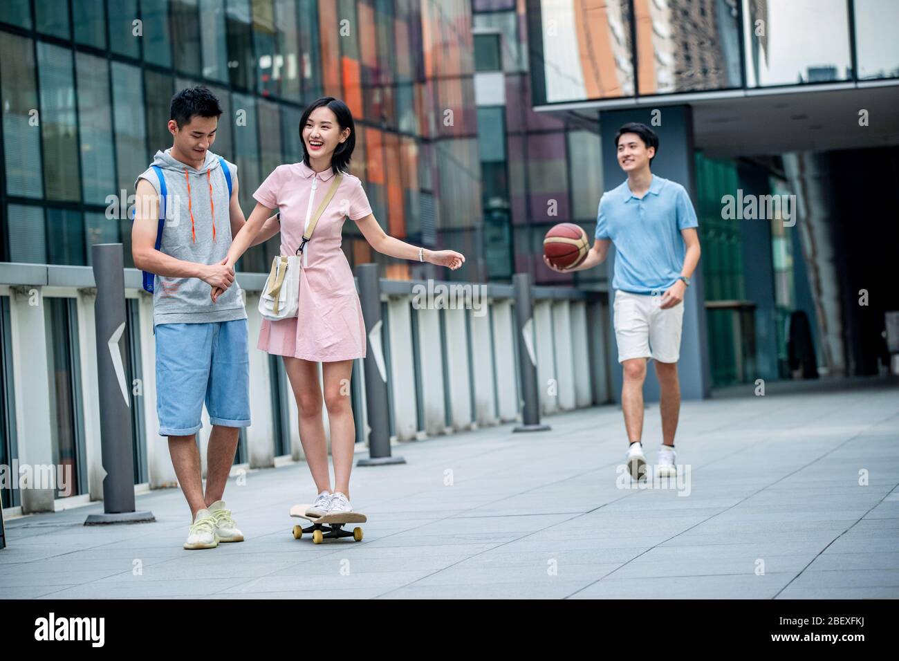 Handsome students goddaughter friend skateboarding Stock Photo