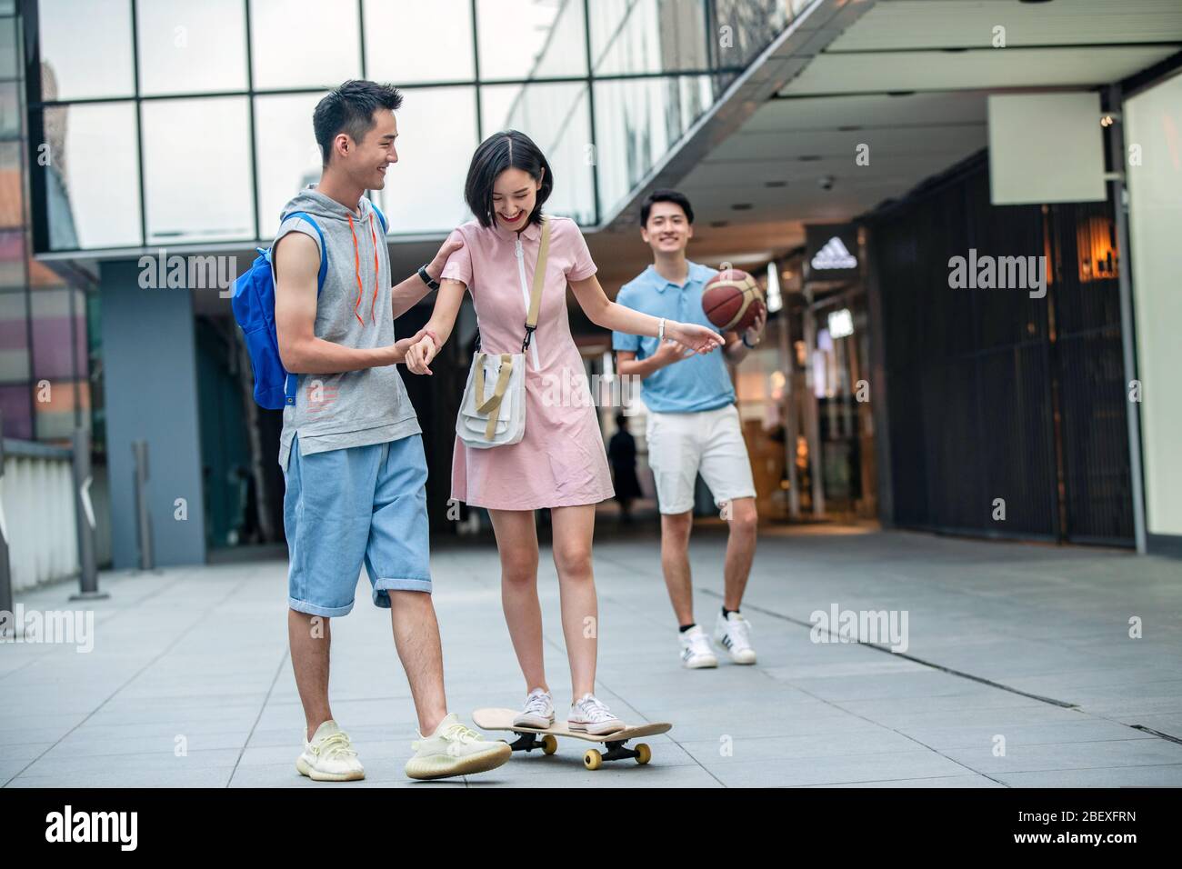Handsome students goddaughter friend skateboarding Stock Photo