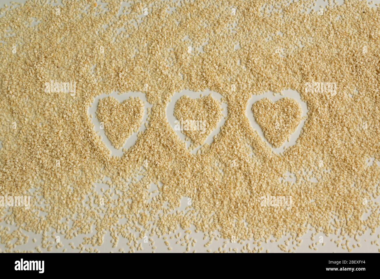 Close up view of dry sesame seeds on white background. Natural oilrich
