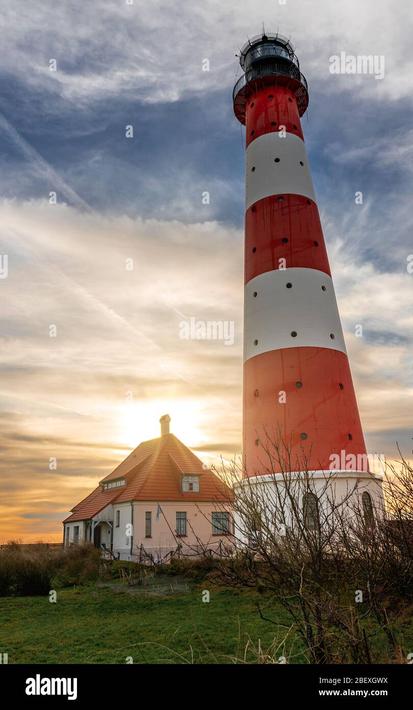 Lighthouse Westerhever near Sankt(St.) Peter Ording at sunset with beautiful stunning sky and dramatic clouds Stock Photo