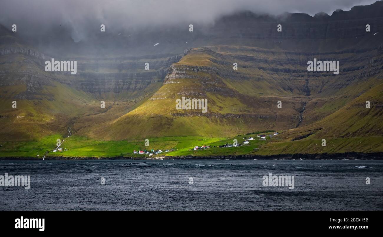 Very small village of Kunoy in Faroe Islands fjord Stock Photo